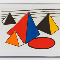 A framed print by Alexander Calder hung on a white wall. The piece shows four abstract pyramids in various colours of red, black, orange, blue and yellow. There are black stripes in the background and a red circle with a black outline in the foreground.
